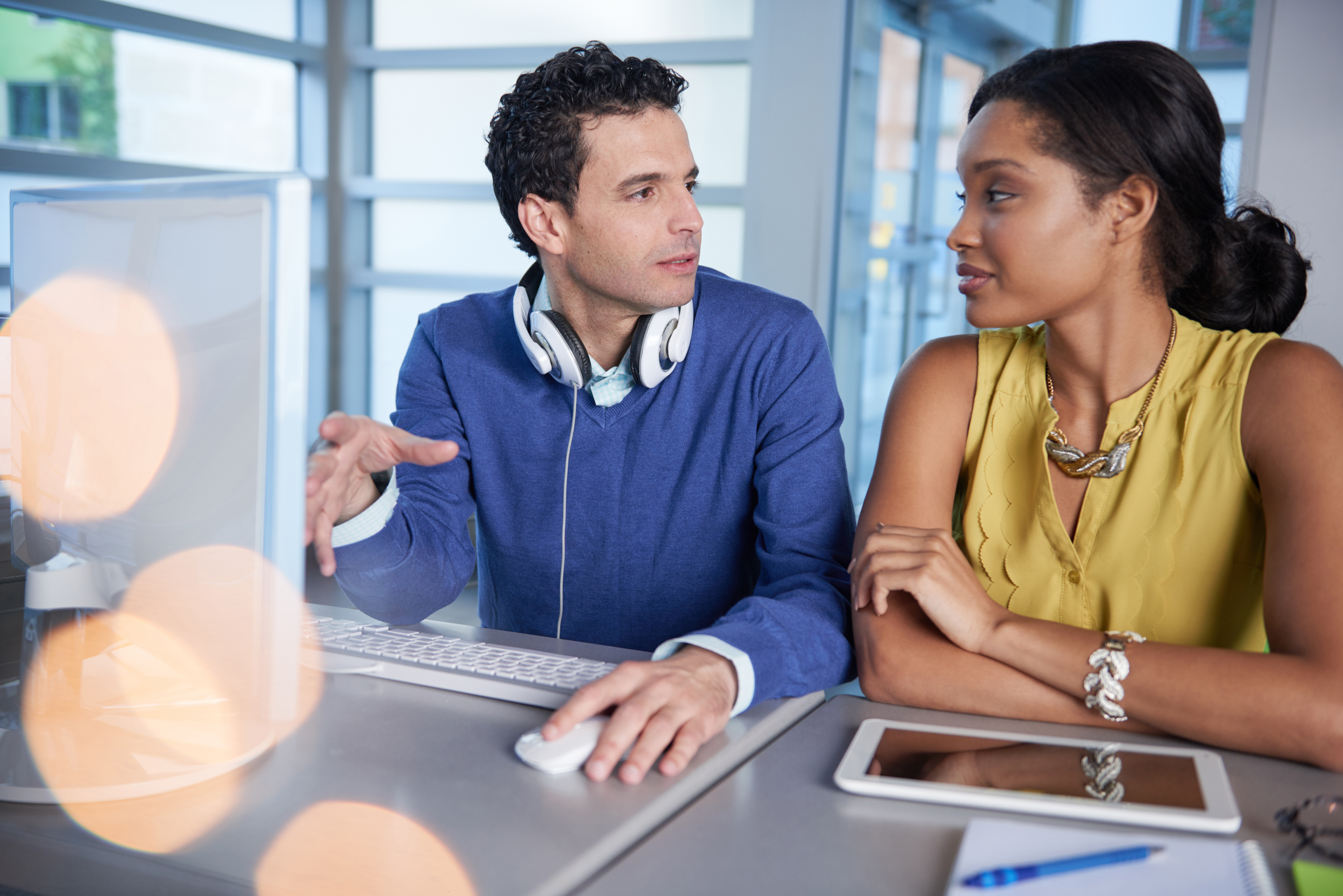 Two people sitting next to each other at work