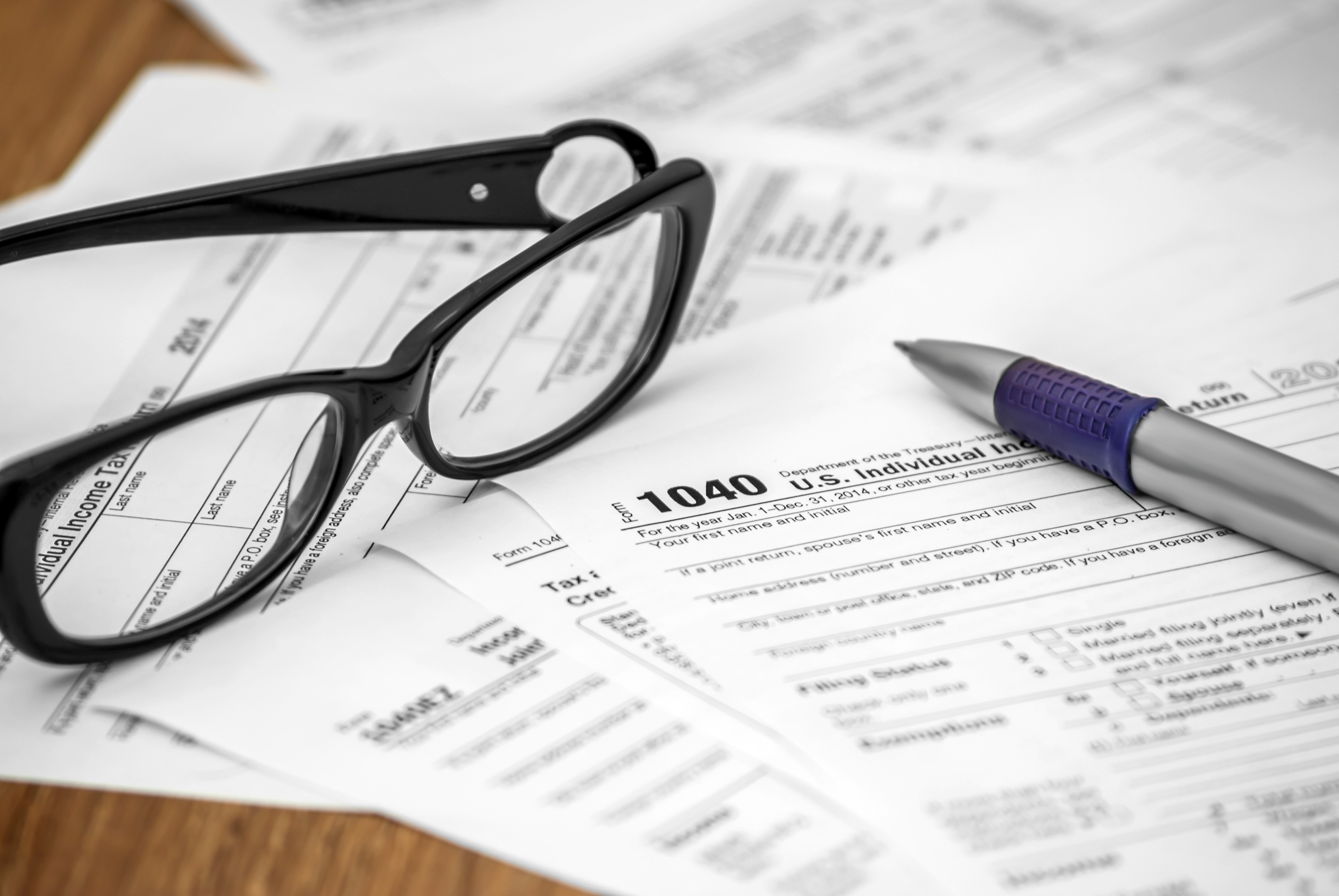 glasses and a 1040 tax form 