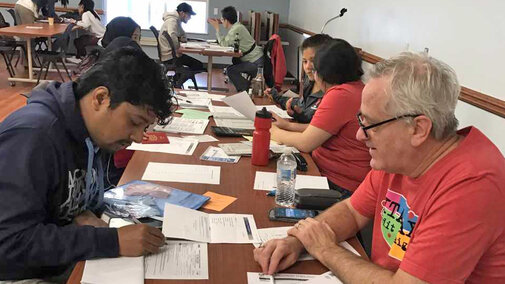 Volunteer and taxpayer sitting across from each other at table